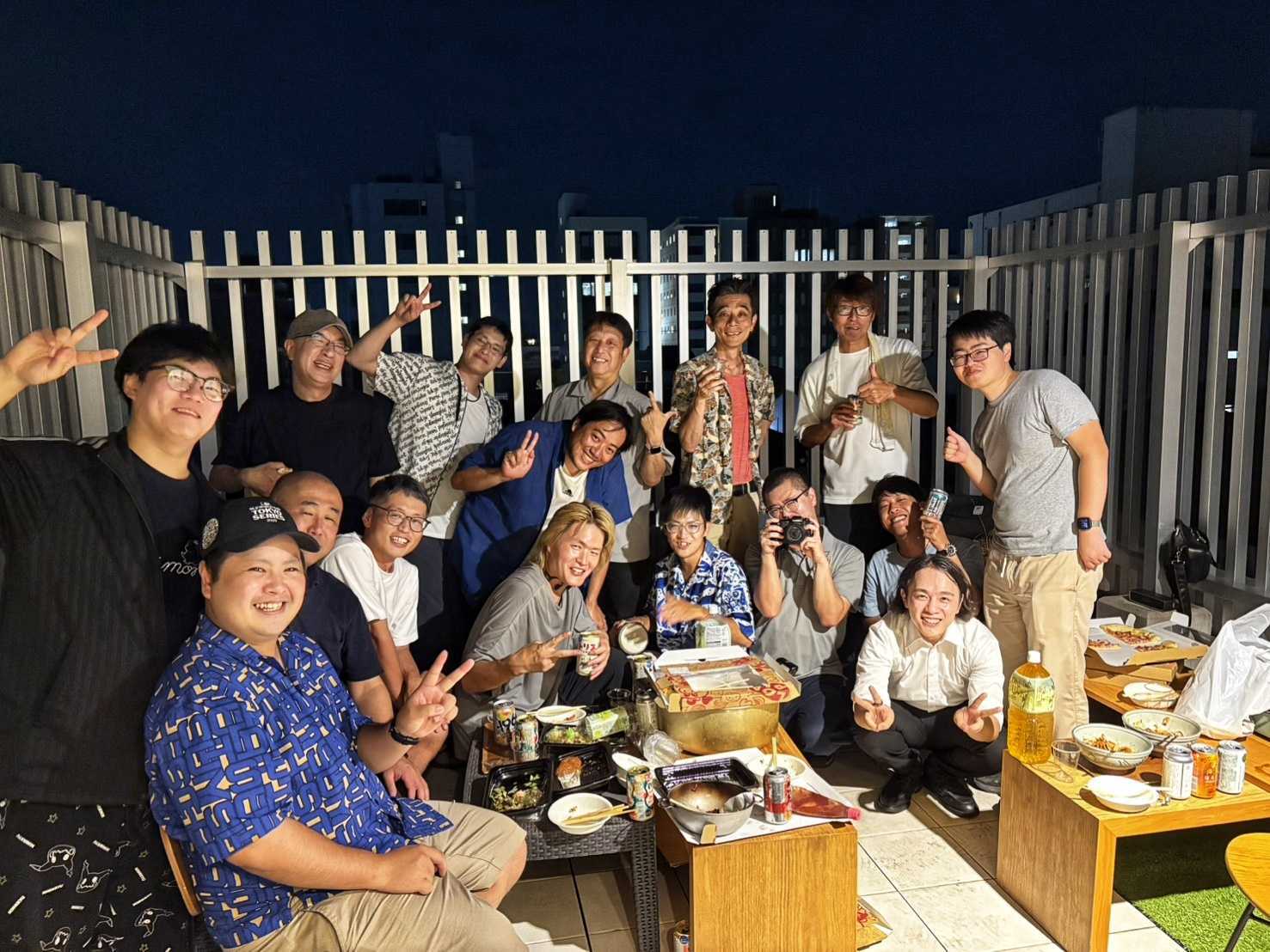 不思議な宿の屋上テラスで食事を囲む夏のITエンジニア交流会の参加者
